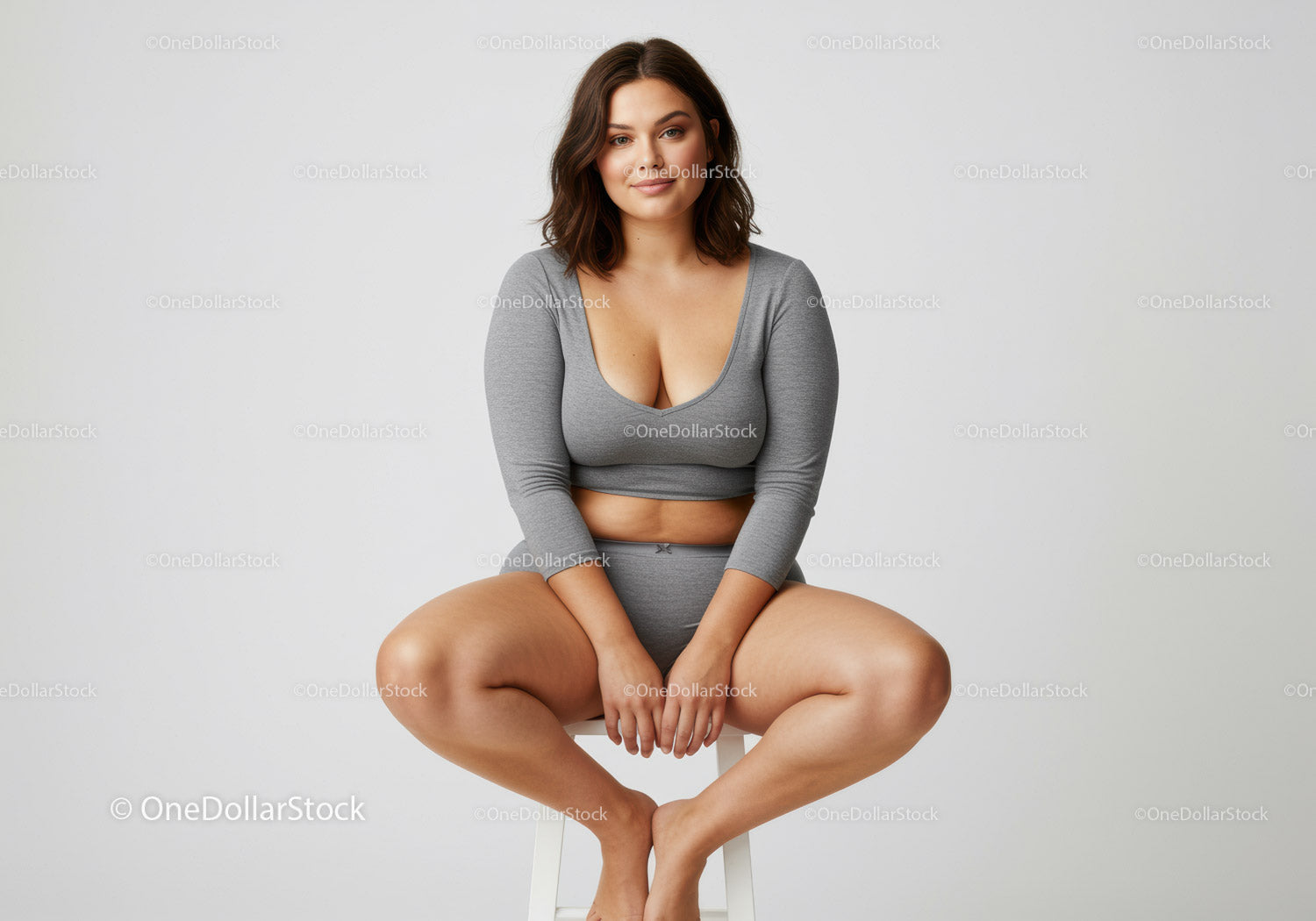 Casual Young Woman in Grey Comfortable Outfit Sitting on a Stool