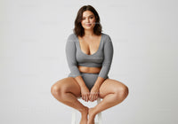 Casual Young Woman in Grey Comfortable Outfit Sitting on a Stool