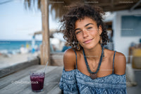 Young Woman Smiling at Seaside Cafe with Ocean View