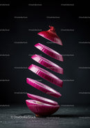 Floating sliced red onion with dark background