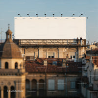 Two people talking near large blank rooftop billboard