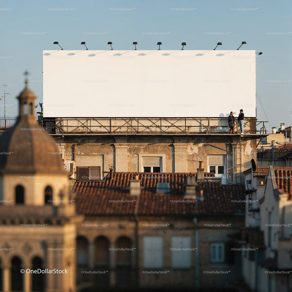 Two people talking near large blank rooftop billboard JPG Mockup Image