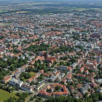 Aerial View of European City with Red Rooftops and Green Parks