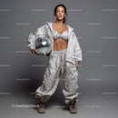 Stylish Woman in Metallic Outfit Holding Disco Ball for Modern Fashion