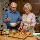 Senior couple preparing colorful appetizers in cozy kitchen