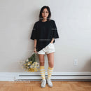 Young Woman in Casual Outfit with Yellow and White Socks Indoors