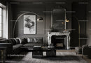 Elegant living room with dark leather sofa and marble fireplace
