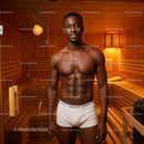 Healthy Muscular Man Relaxing in Wooden Sauna Room