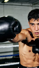 Focused young boxer training with intense determination