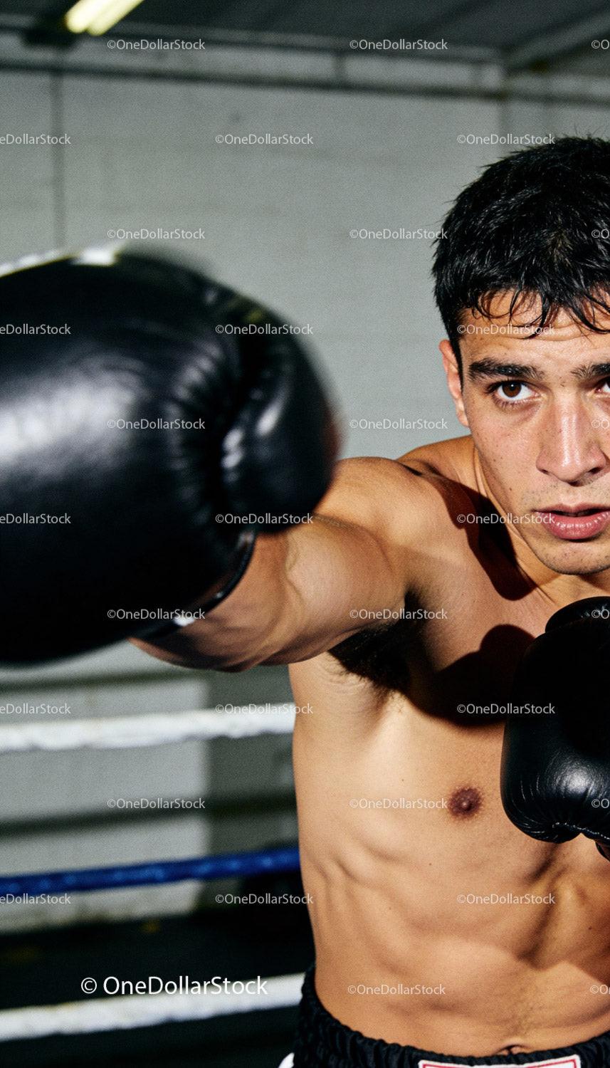 Focused young boxer training with intense determination
