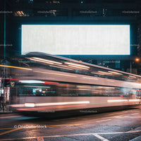 Blurred double-decker bus speeding through night city street