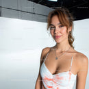 Stylish Young Woman in White Tie-Dye Crop Top Portrait