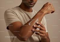 Focus on Man Applying Sunscreen Lotion on Forearm for Skin Protection