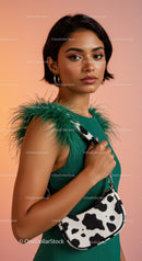 Stylish Woman in Green Dress with Cow Print Bag and Silver Earrings