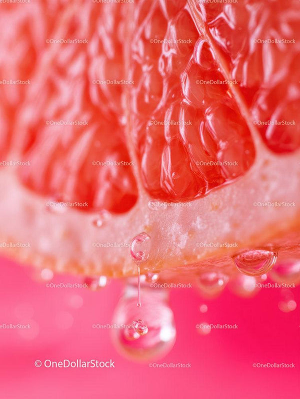 Close-up of Juicy Red Grapefruit Slice with Water Droplets