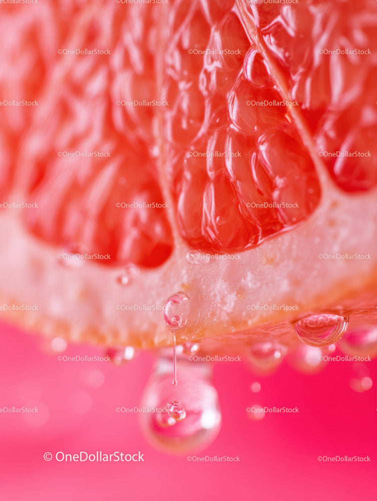 Close-up of Juicy Red Grapefruit Slice with Water Droplets