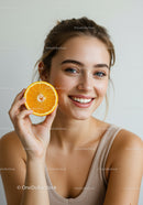 Young Woman Holding Fresh Orange Half Brightening Smile
