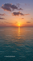 Serene Sunset over Calm Ocean with Colorful Sky and Clouds