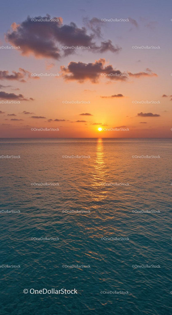 Serene Sunset over Calm Ocean with Colorful Sky and Clouds