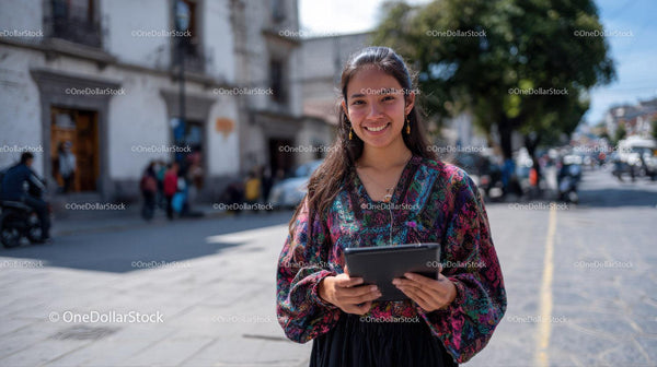 Young Woman Smiling Holding Tablet in Urban Street Scene