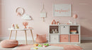 Soft Pink and White Children's Nursery with Playful Decor and Wooden Accents