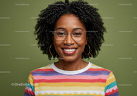 Portrait of a Smiling Young Woman with Curly Hair Wearing Colorful Striped Shirt