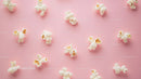 Popcorn scattered on pink background with fresh crunchy snack imagery