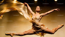 Graceful ballerina mid-air performing an elegant leap
