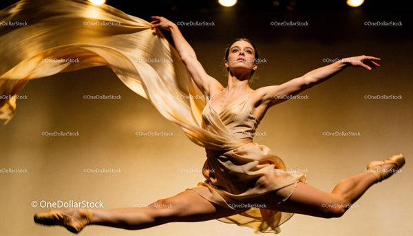 Graceful ballerina mid-air performing an elegant leap