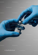 Close-up of hands in blue gloves handling a medical vaccine vial
