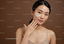Young Woman Applying Facial Moisturizer for Skincare Routine
