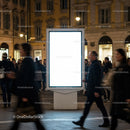 Urban Night Scene with Blank Digital Billboard and Pedestrians
