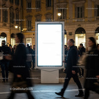 Urban Night Scene with Blank Digital Billboard and Pedestrians