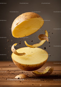 Fresh potato halves suspended with peeling in motion
