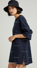 Fashionable Woman Wearing Navy Dress and Black Bucket Hat
