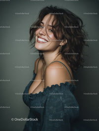 Joyful Woman with Curly Hair Wearing Jewelry in Studio Portrait
