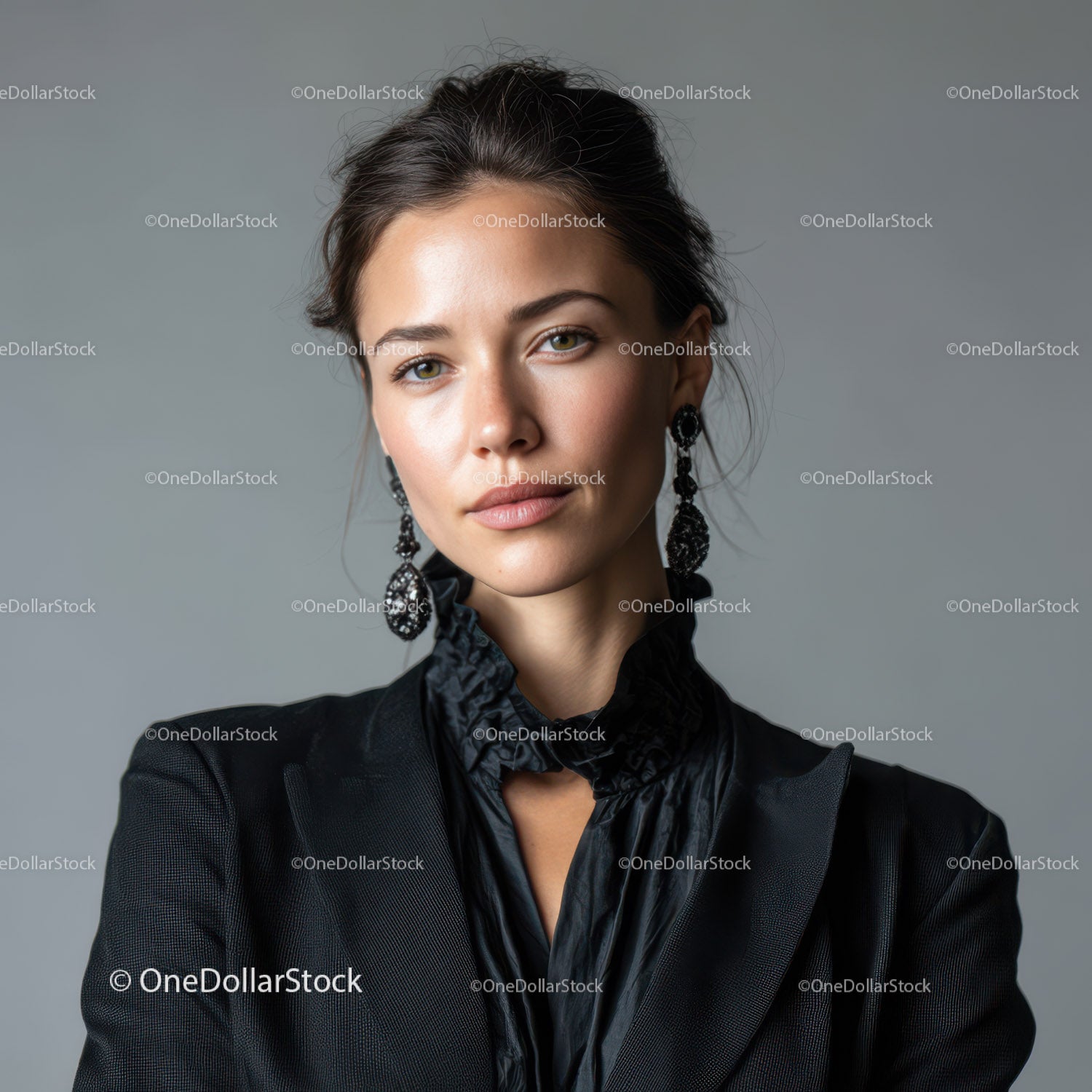 Elegant Woman in Black Blazer with Stylish Earrings Looking at Camera