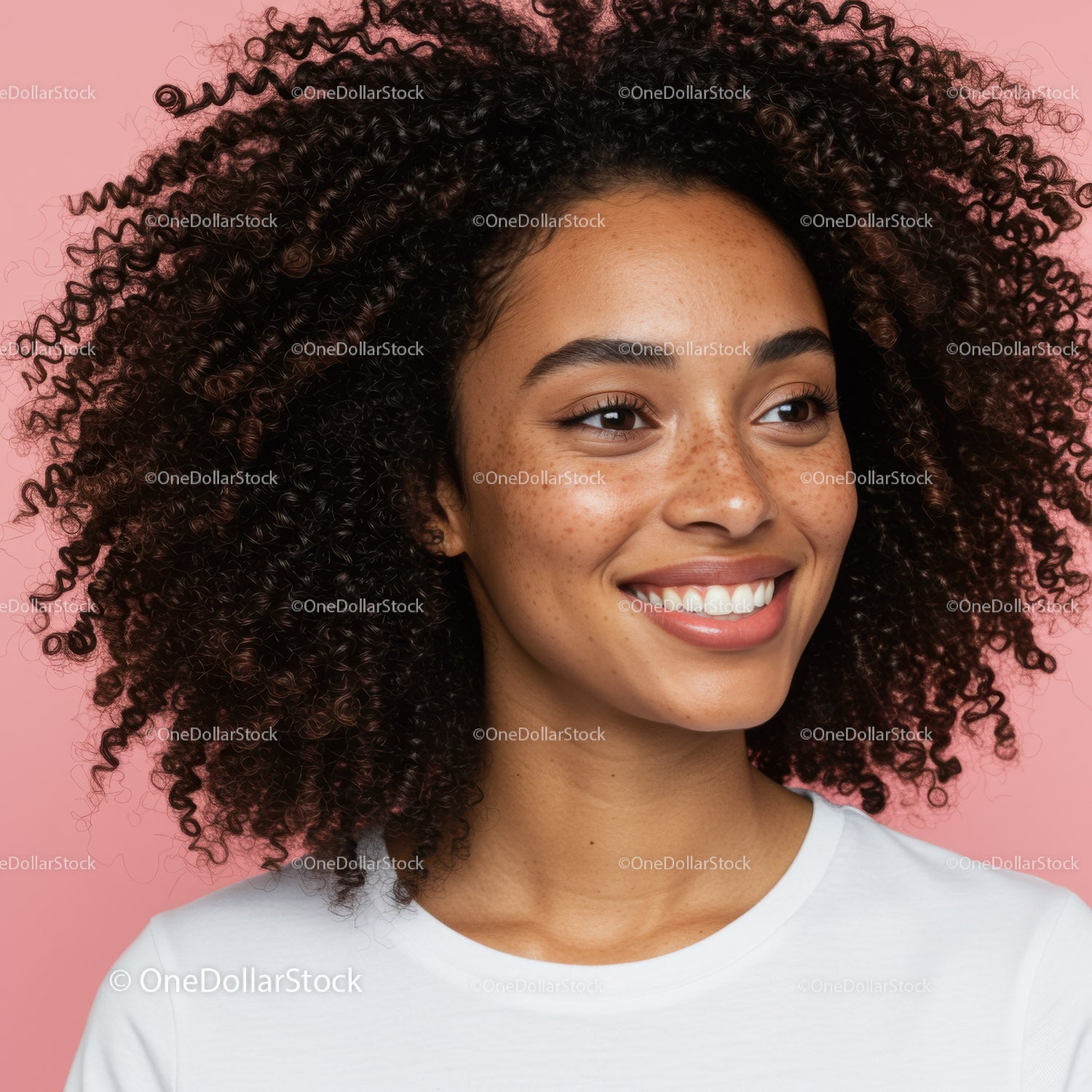 Vibrant Woman with Curly Hair Smiling Against Pink Background