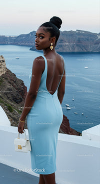 Elegant woman in blue dress admiring ocean view