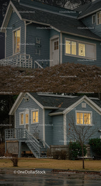 Cozy blue house with warm glowing windows at dusk
