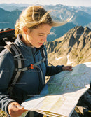 Woman Hiking in Mountains Exploring Trail Map