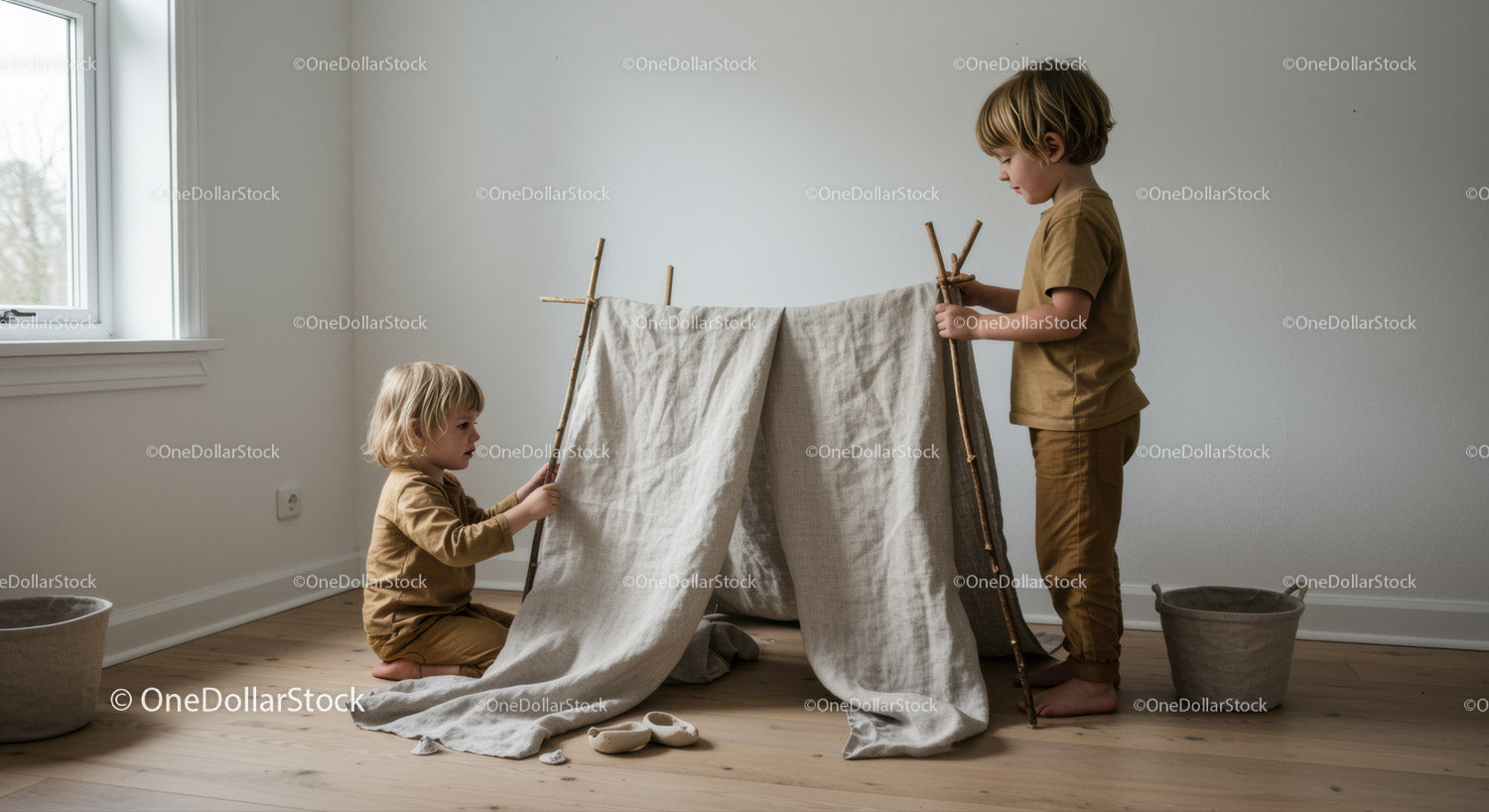 Two children building a cozy indoor play tent at home