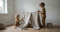 Two children building a cozy indoor play tent at home
