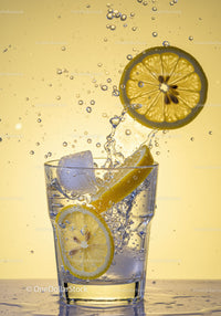 Refreshing lemon slices splashing into sparkling water
