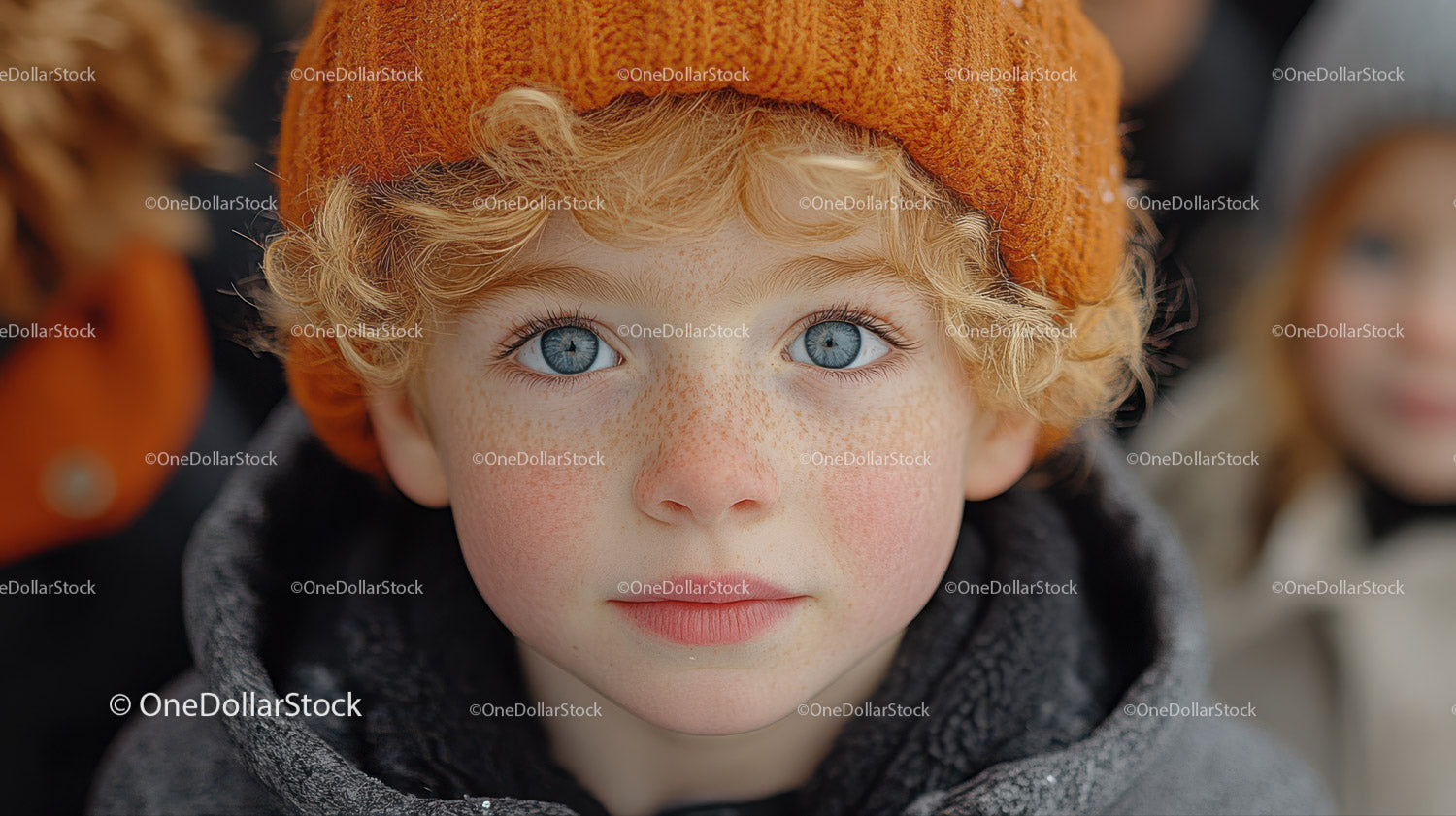 Close-up of a Boy with Blue Eyes and Curly Blonde Hair Wearing an Orange Beanie