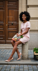 Young woman sitting outdoors with fresh groceries