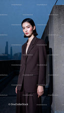 Confident woman in brown modern suit outdoors