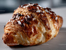 Chocolate Chip Croissant with Powdered Sugar and Crispy Flaky Layers