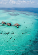 Overwater Bungalows Over Clear Turquoise Ocean with Tropical Setting