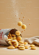 Mini Pancakes Falling Out of Open Packaging with Powder